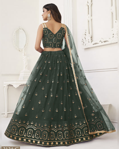 Green embroidered lehenga with gold details on a white background