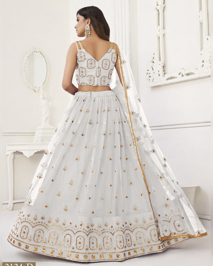 White embroidered traditional outfit with gold details on a white background