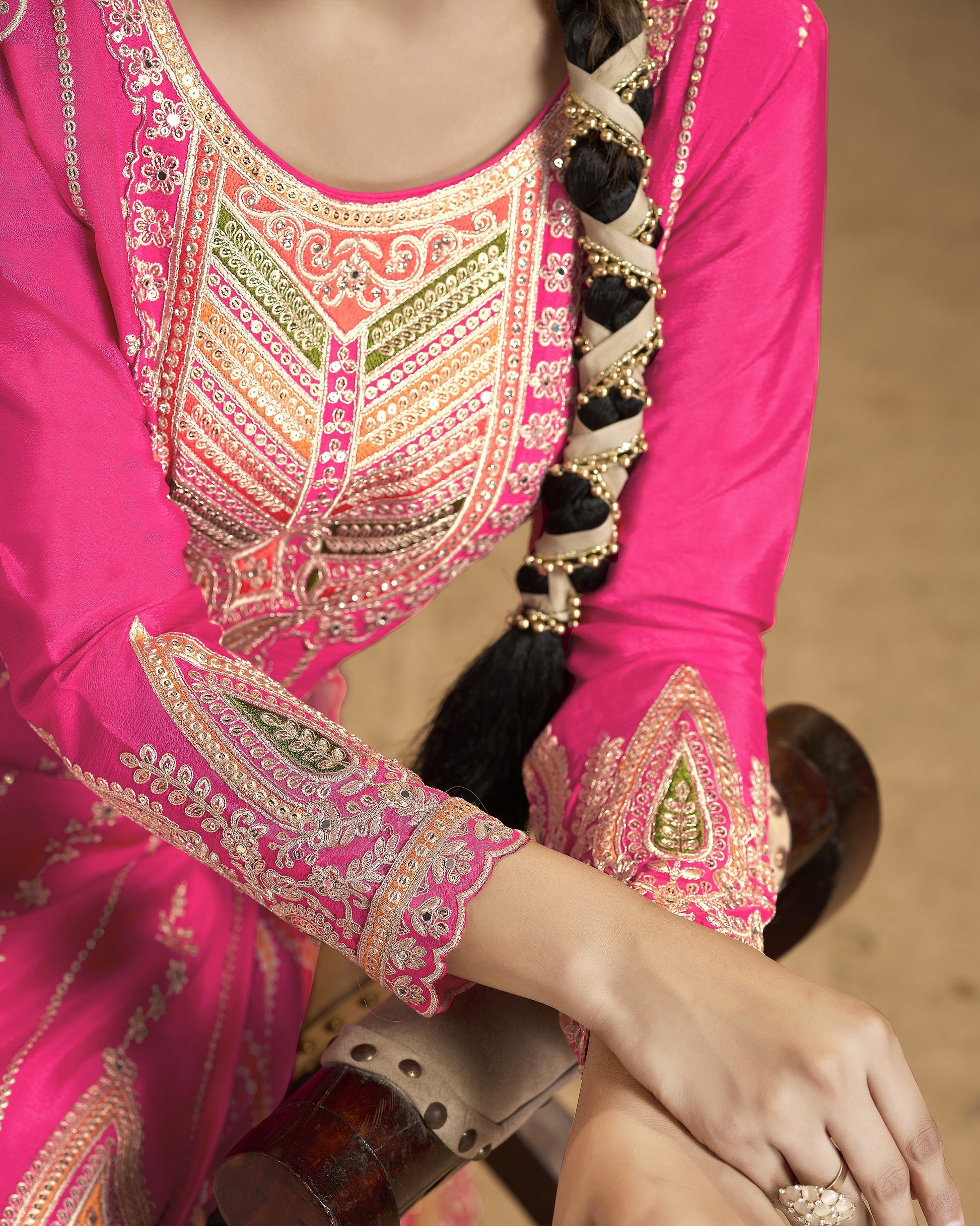 Close-up of a pink traditional outfit with intricate embroidery.
