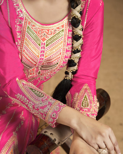 Close-up of a pink traditional outfit with intricate embroidery.