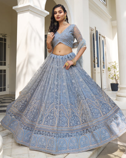 Woman wearing a blue embroidered lehenga in an outdoor setting