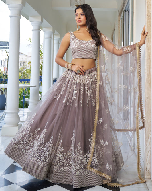 Woman in a traditional outfit with floral patterns standing on a checkered floor.