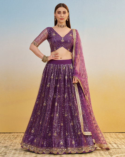 Woman wearing a purple embroidered lehenga with a matching blouse against a gradient background
