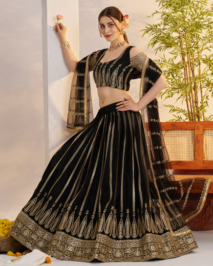 Woman wearing a black and gold traditional outfit with a white background