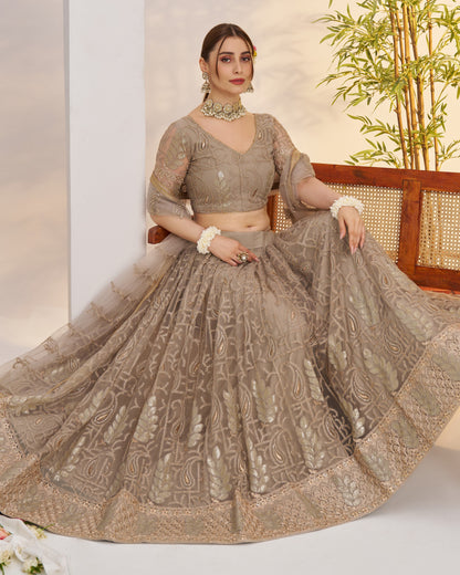 Woman in a traditional outfit with intricate patterns, sitting on a chair.