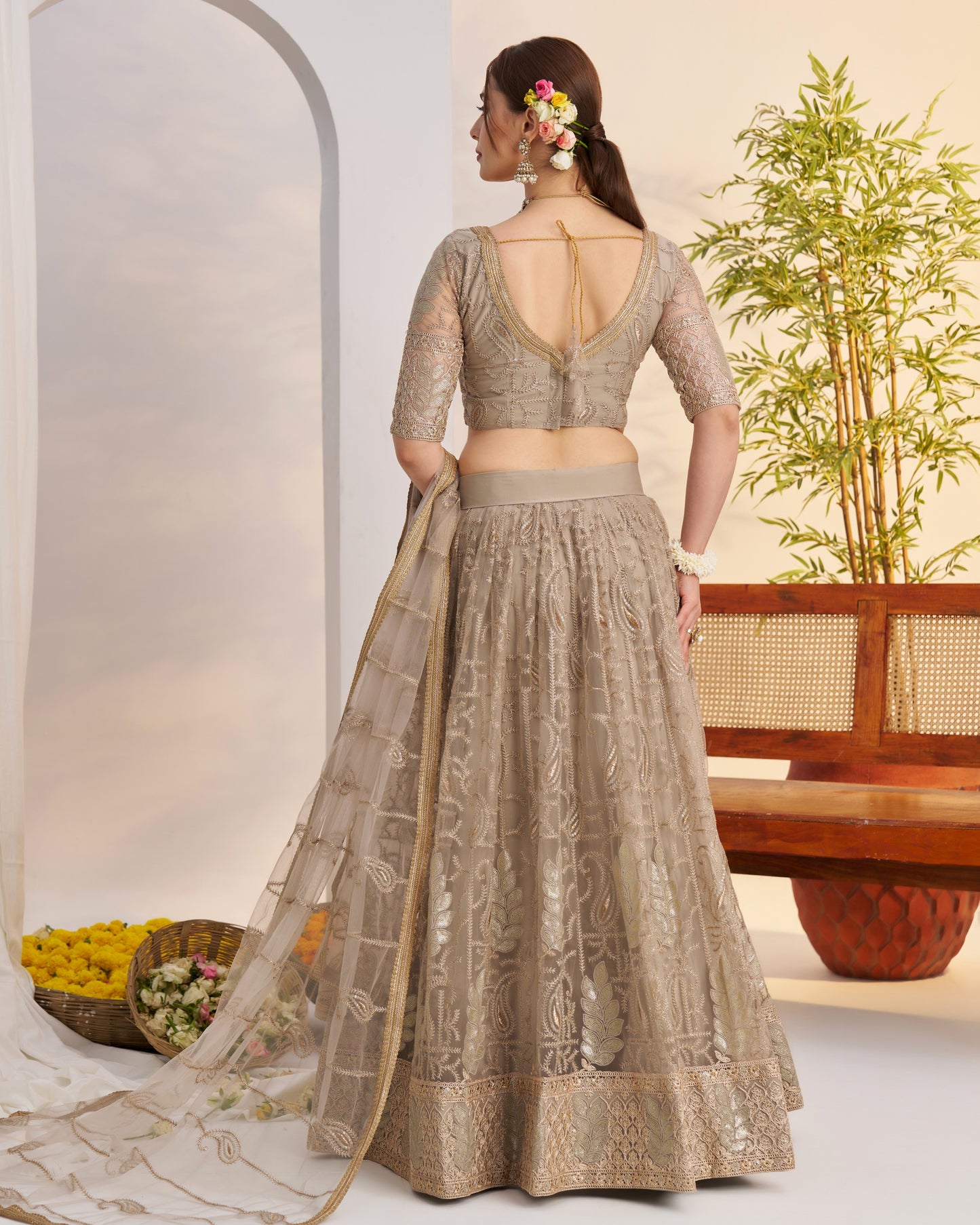 Woman in a traditional outfit with a white background and decorative elements.