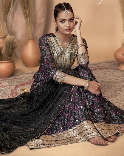 Woman in a traditional outfit with intricate designs sitting on a patterned rug.