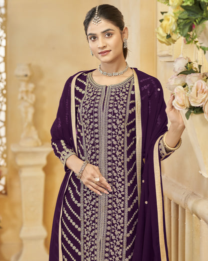 Woman in a purple traditional outfit with floral decorations in the background