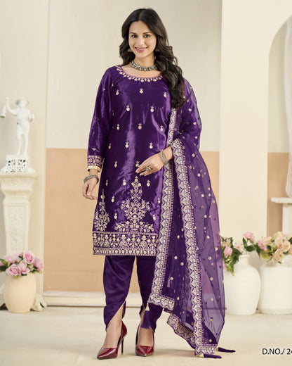 Woman wearing a purple embroidered outfit with a white background