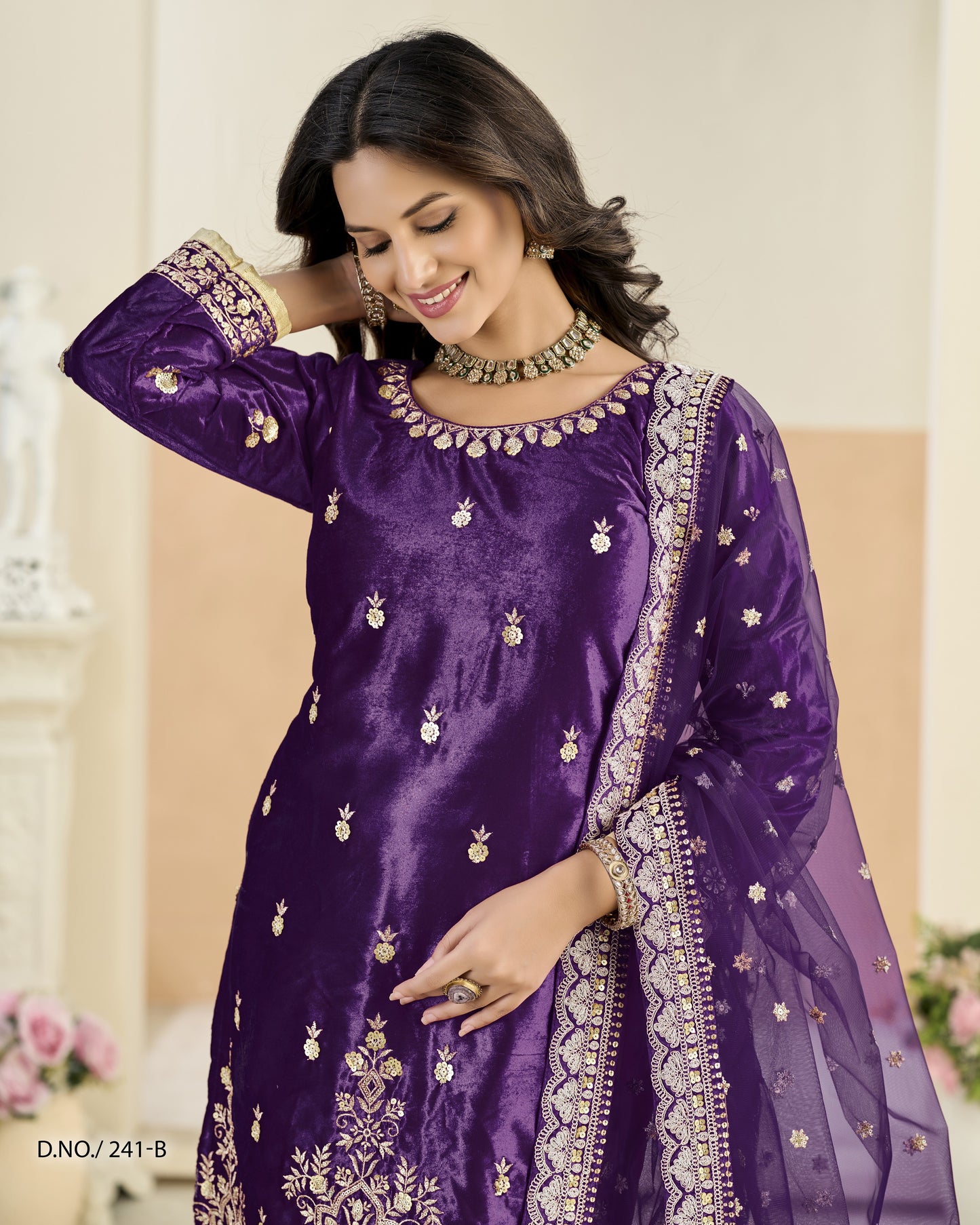 Woman wearing a purple embroidered traditional outfit with a blurred background