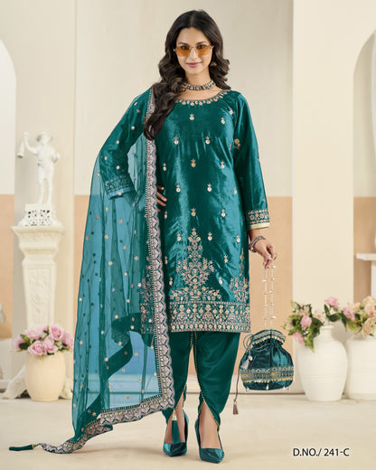Woman in teal embroidered outfit with dupatta in a decorated room