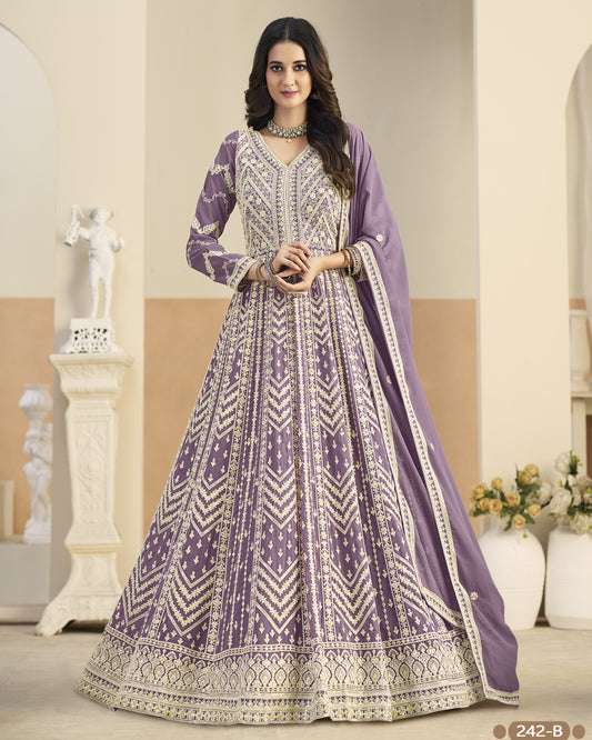 Woman wearing a purple and white patterned dress in an indoor setting