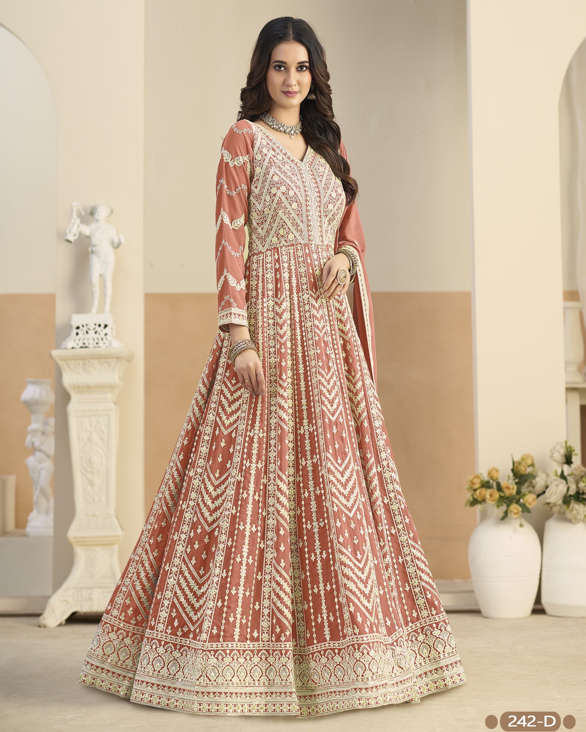 Woman wearing a patterned dress in an elegant indoor setting