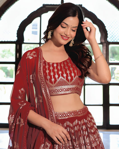 Woman wearing a red embroidered saree with a blurred background