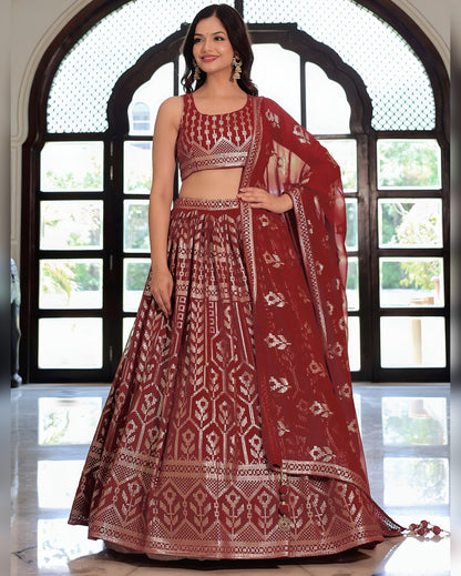 Woman wearing a red and white patterned traditional outfit in front of a large window.