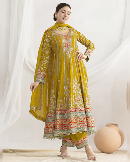 Woman wearing a yellow embroidered traditional outfit on a white background