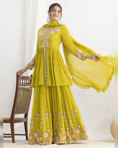 Woman wearing a yellow embroidered traditional outfit with a white background