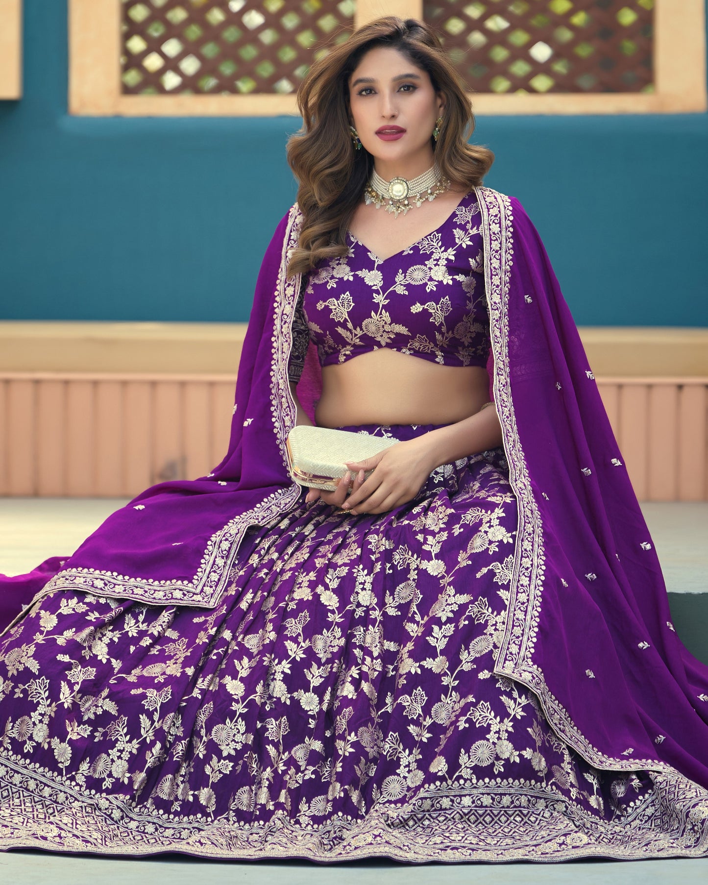 Woman in a purple embroidered traditional outfit with a blue background