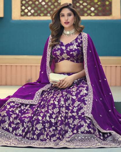 Woman in a purple embroidered traditional outfit with a blue background
