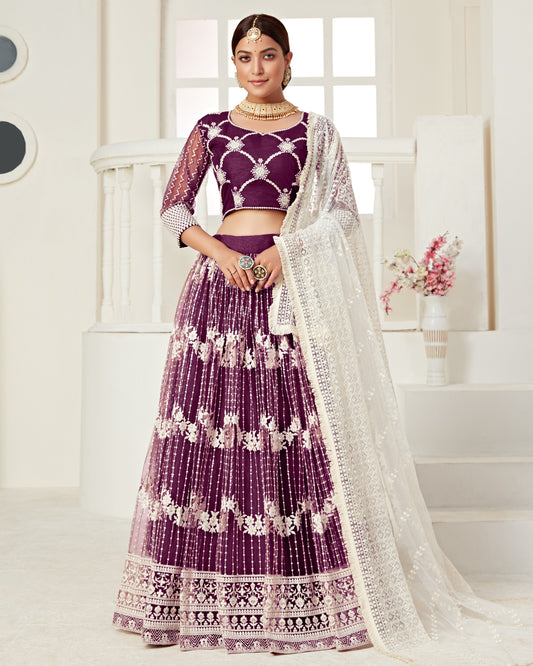 Woman wearing a purple and white traditional outfit with a white background