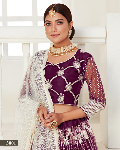 Woman wearing a traditional purple and white outfit with jewelry against a white background