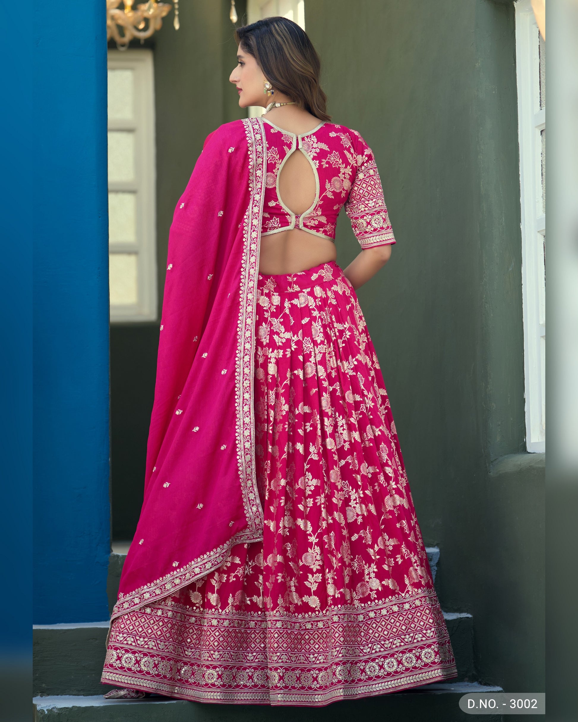 Woman wearing a pink traditional outfit with a blue background