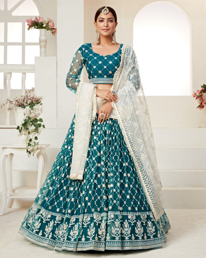 Woman wearing a teal and white traditional outfit with a white background