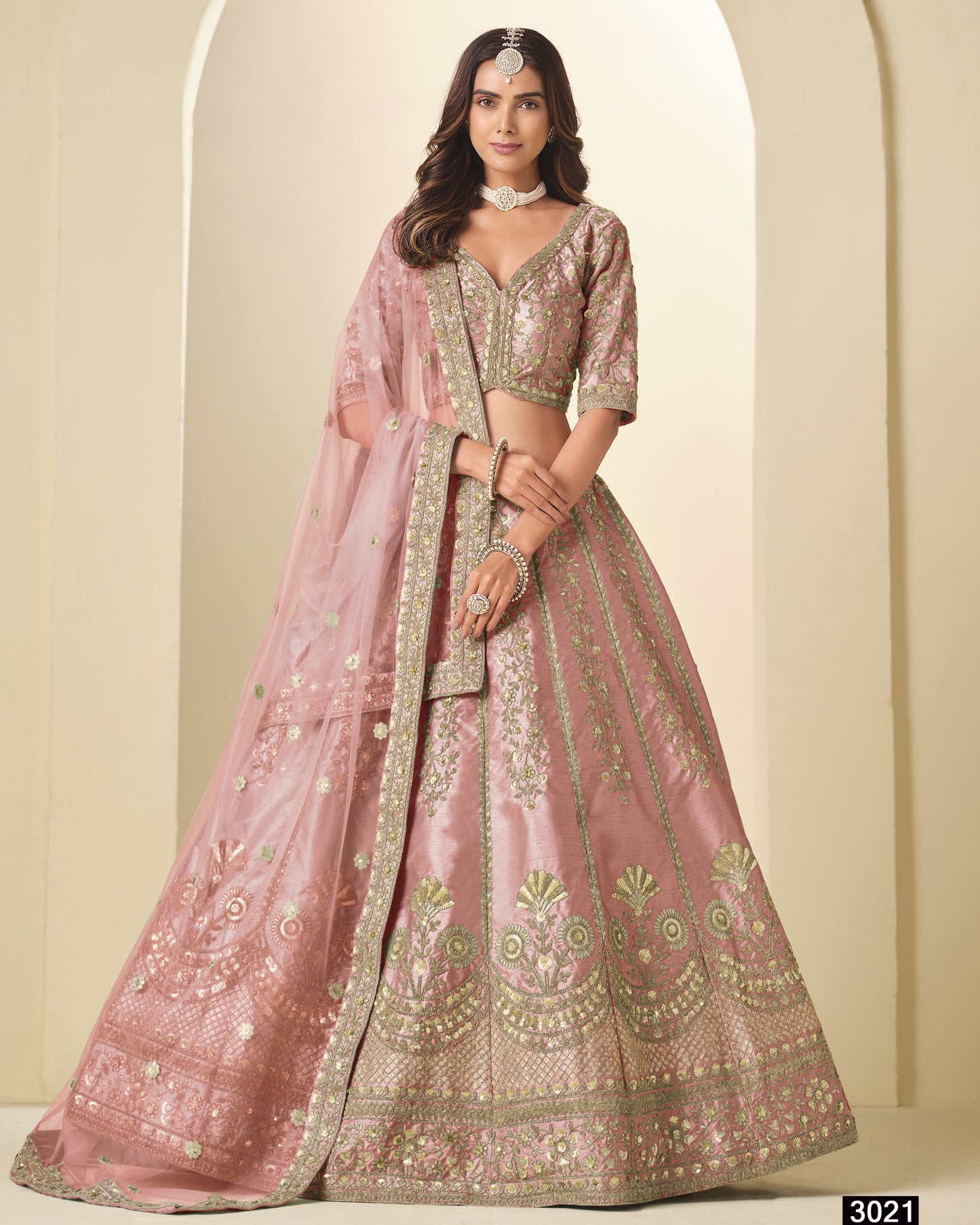 Pink embroidered lehenga with matching blouse on a neutral background