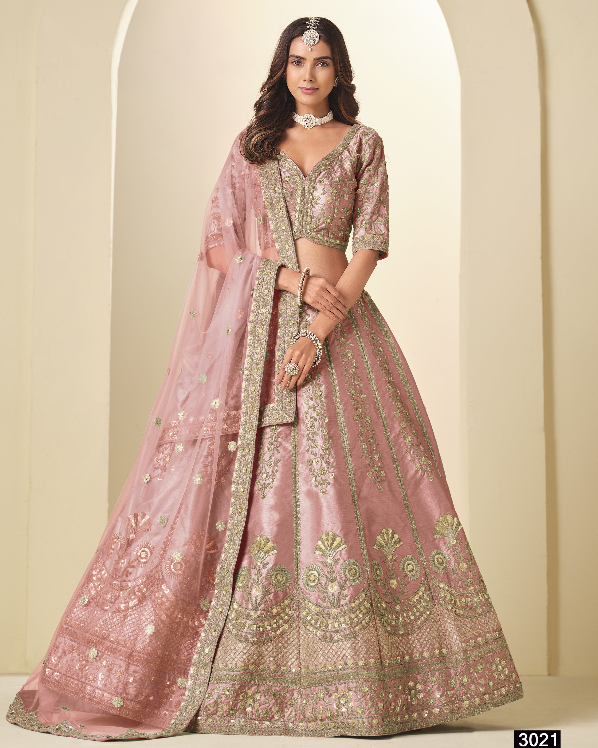 Pink embroidered lehenga with matching blouse on a neutral background