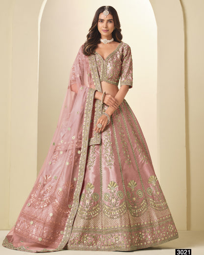 Pink embroidered lehenga with matching blouse on a neutral background