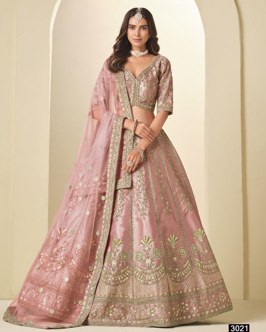 Pink embroidered lehenga with matching blouse on a neutral background