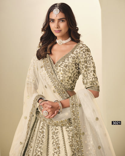 Woman wearing a traditional embroidered outfit with a plain background