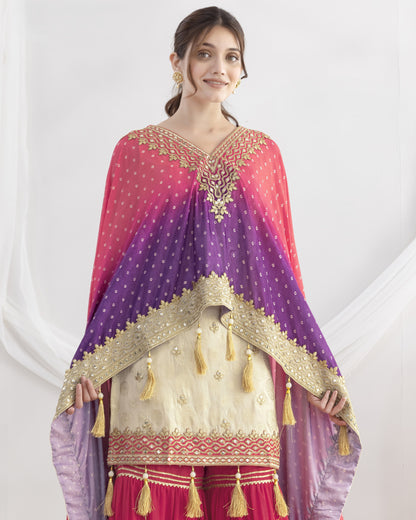 Woman wearing a traditional outfit with a pink and purple dupatta on a white background