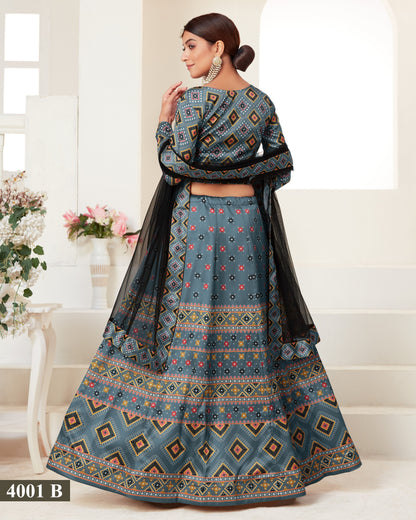 Woman wearing a blue patterned traditional outfit with a black dupatta in a bright room.