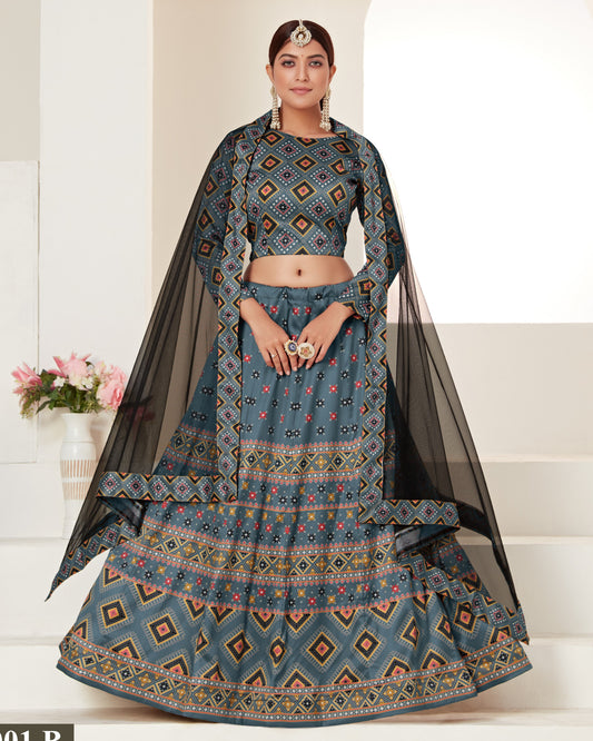 Woman wearing a traditional blue patterned outfit with a black dupatta on a white background