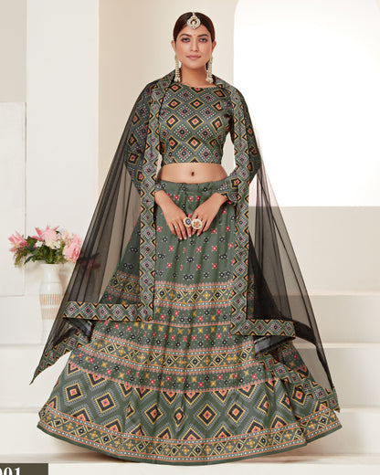 Woman wearing a traditional green and black patterned outfit with a white background