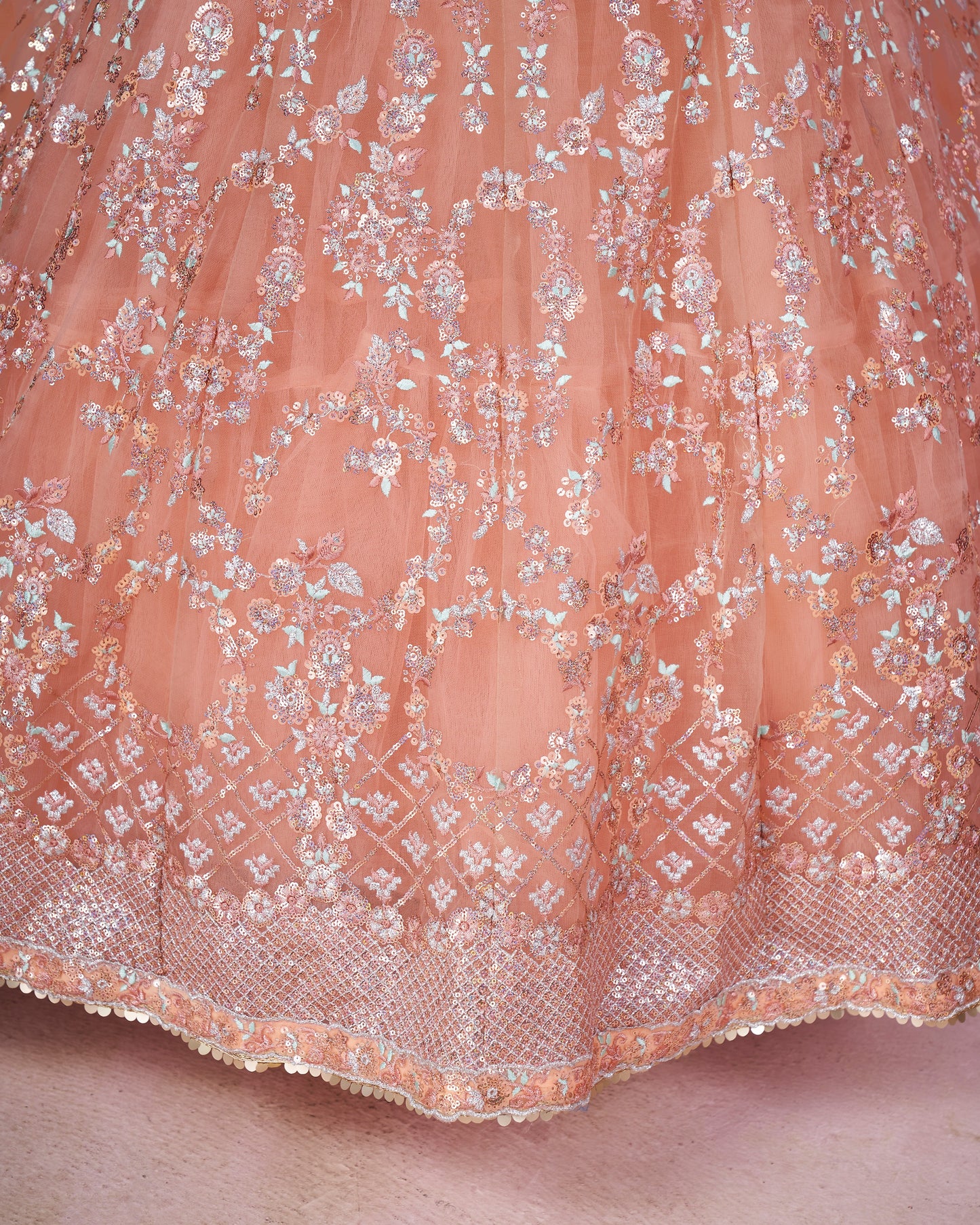 Close-up of a pink lace fabric with floral patterns