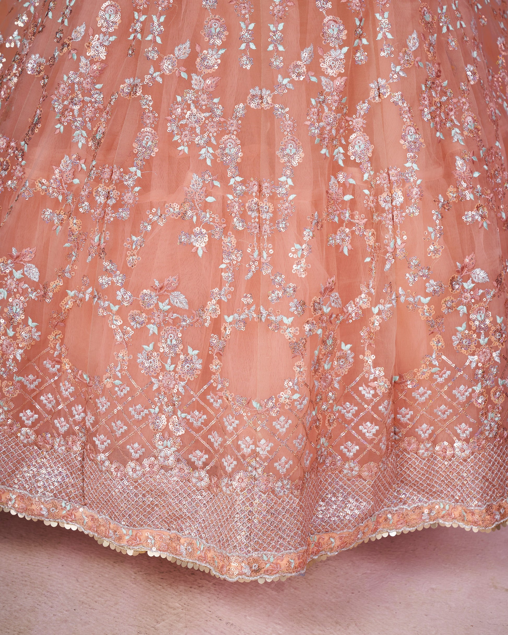 Close-up of a pink lace fabric with floral patterns