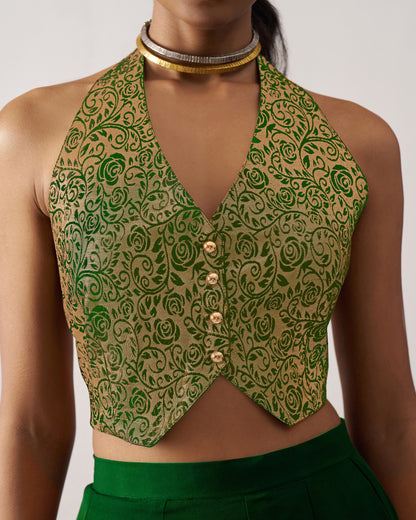 Green patterned crop top worn by a person on a plain background