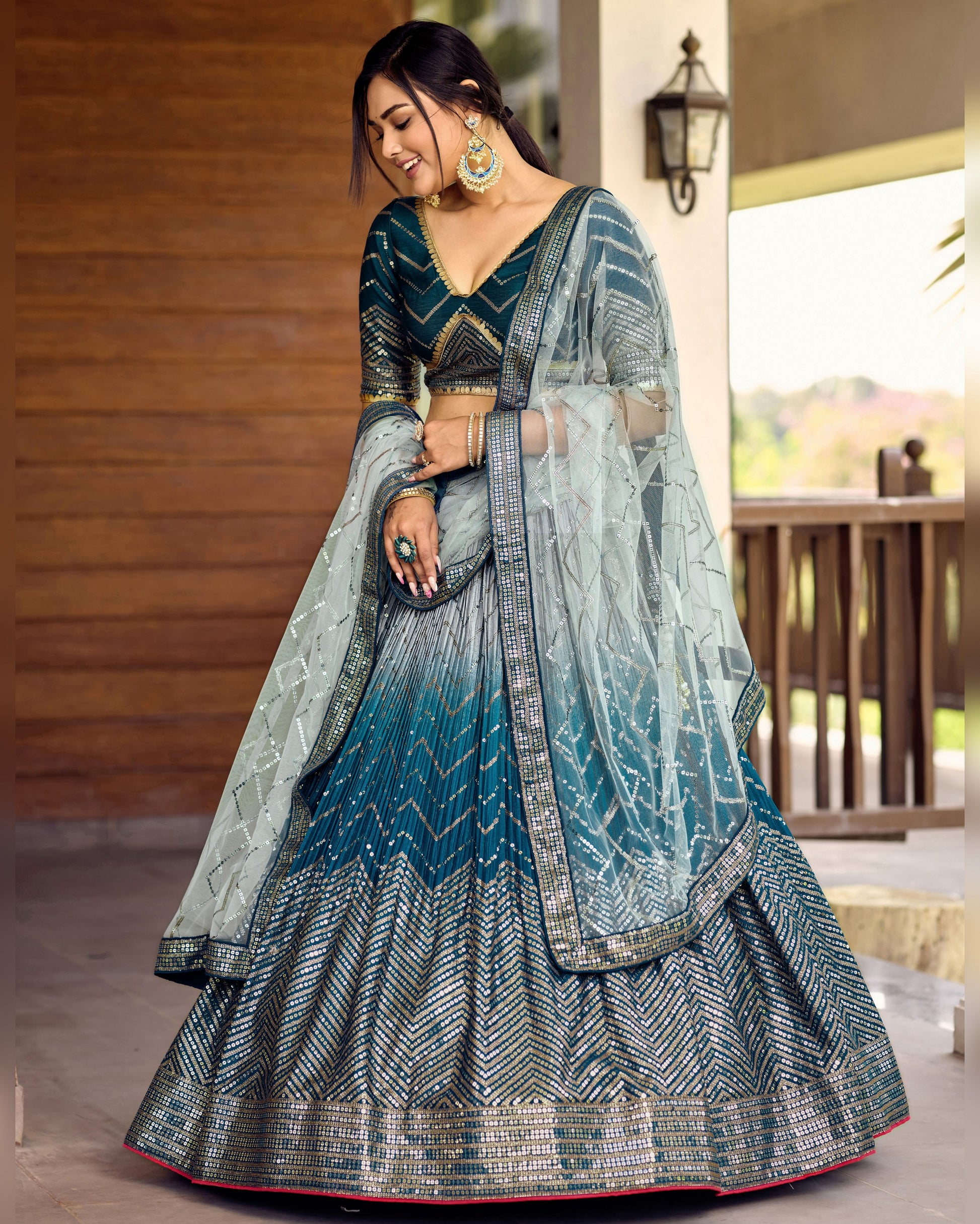 Woman wearing a traditional outfit with a gradient design in an outdoor setting