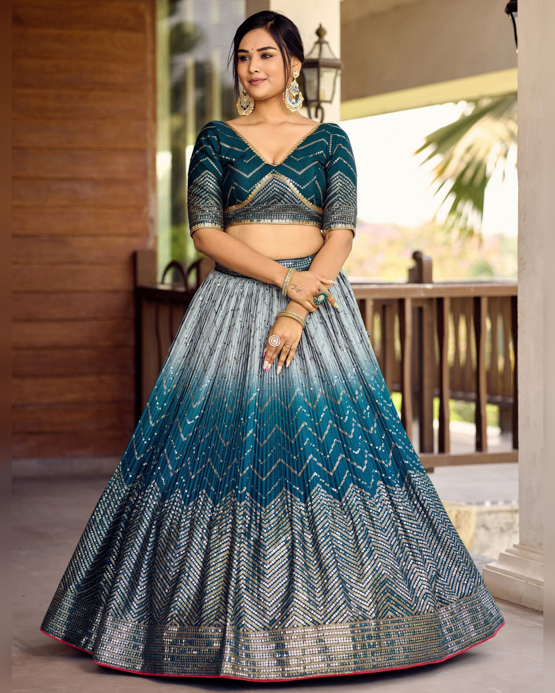 Woman wearing a blue and gray traditional outfit with a blurred outdoor background