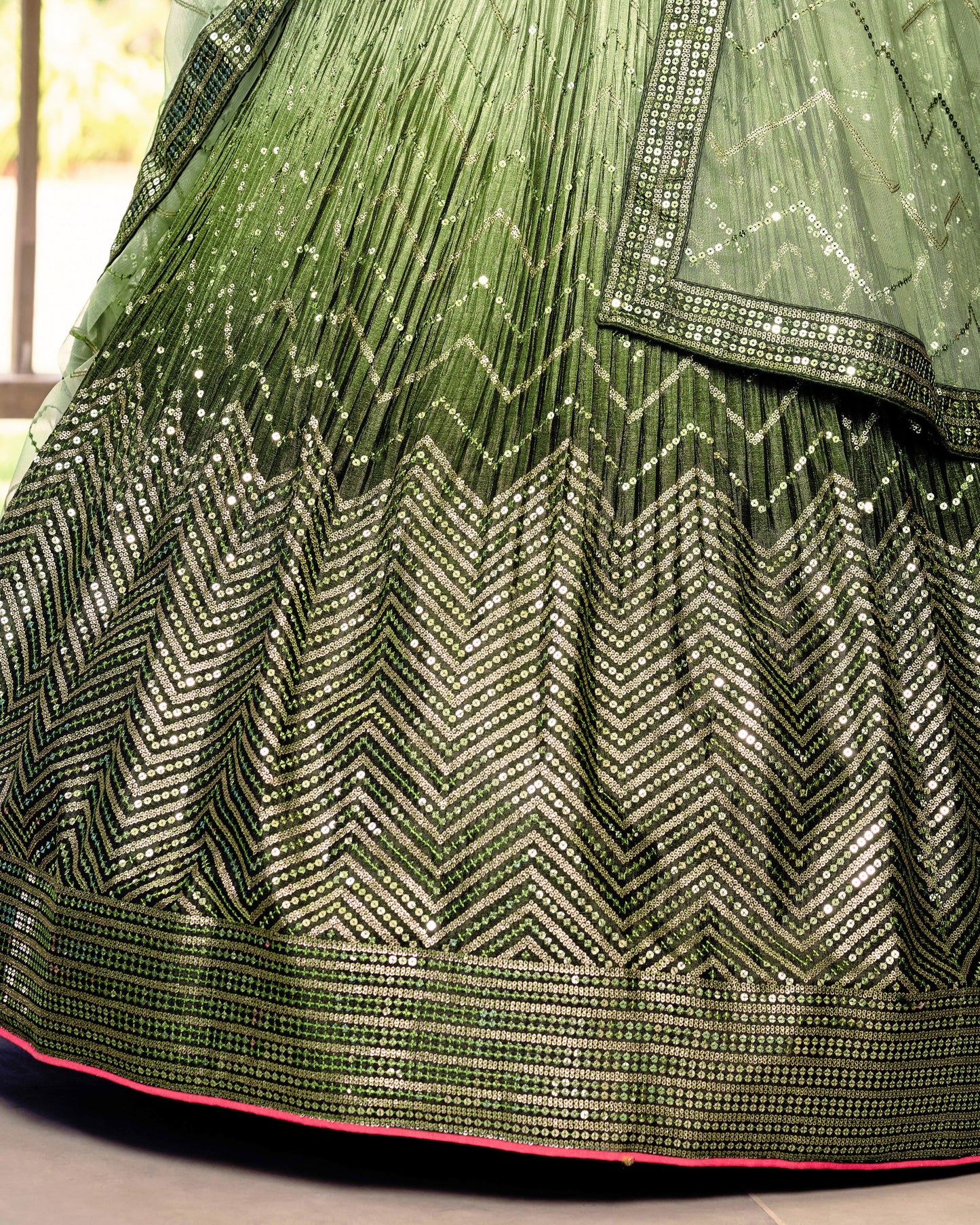 Green and gold traditional fabric with intricate patterns