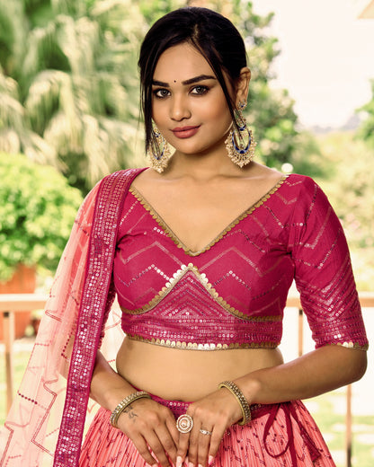 Woman wearing a pink traditional outfit with a blurred green background