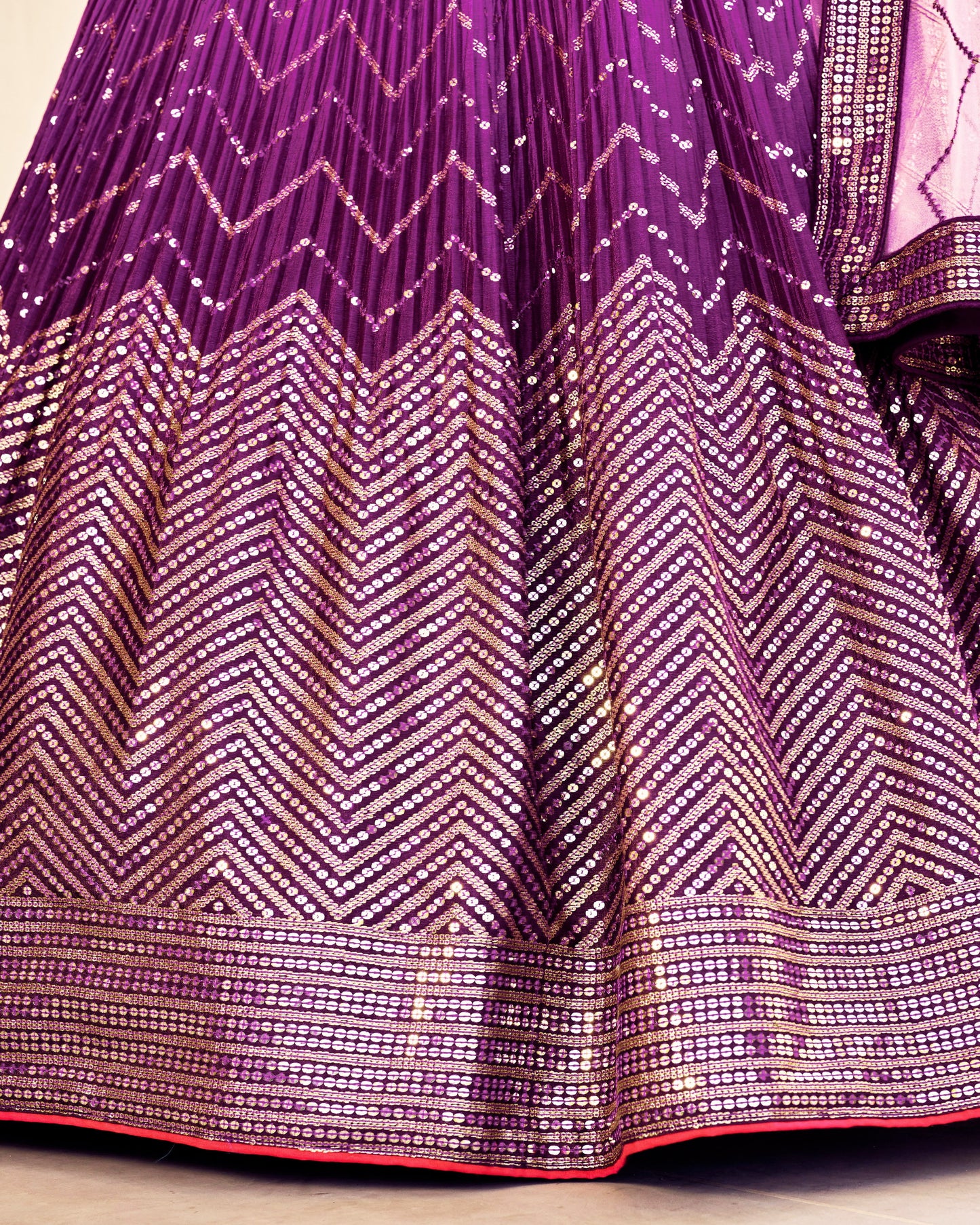 Close-up of a purple fabric with gold zigzag pattern