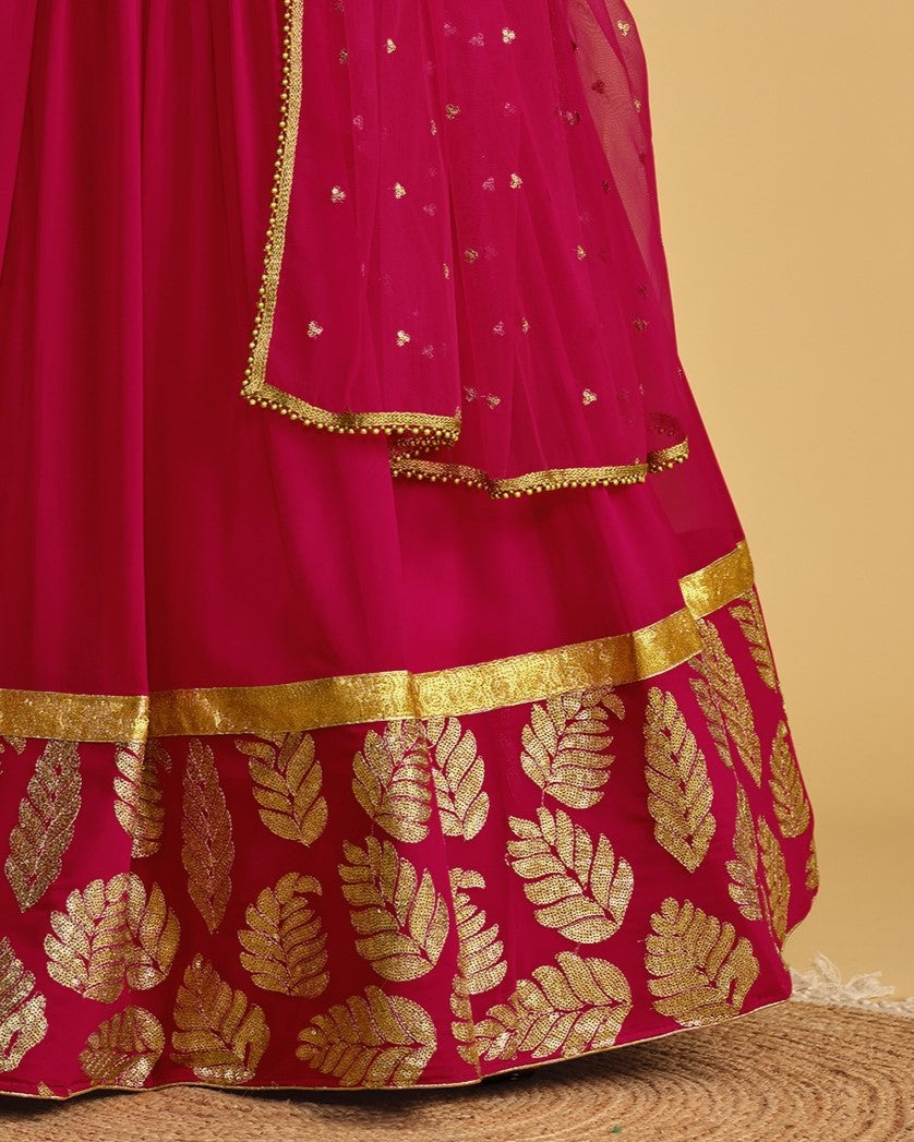 Pink traditional outfit with gold leaf patterns and border on a beige background