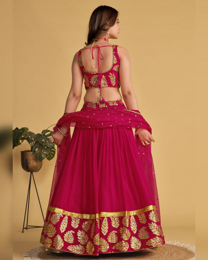 Woman wearing a pink and gold traditional outfit with a beige background