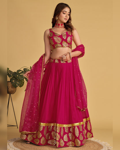 Woman wearing a pink and gold traditional outfit on a beige background