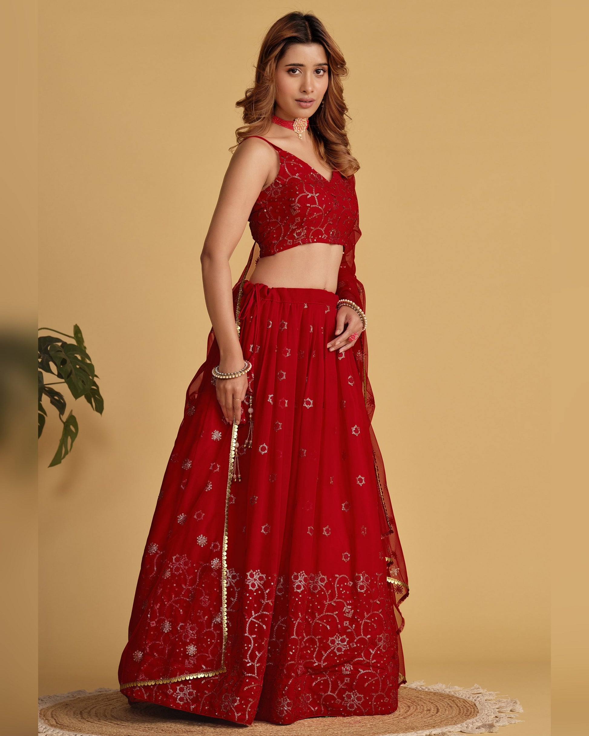 Woman wearing a red embroidered traditional outfit on a beige background