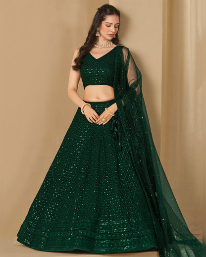 Woman wearing a green traditional outfit with a beige background