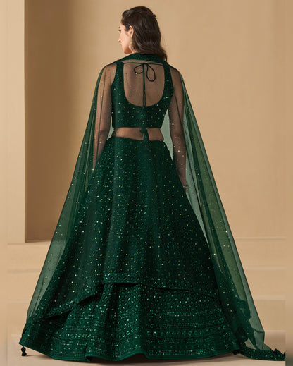 Green traditional outfit with a sheer cape on a beige background